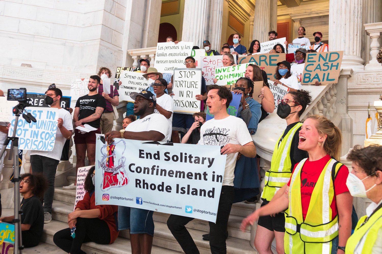 Stop Torture RI rally at the State House with an End Solitary Confinement in Rhode Island banner