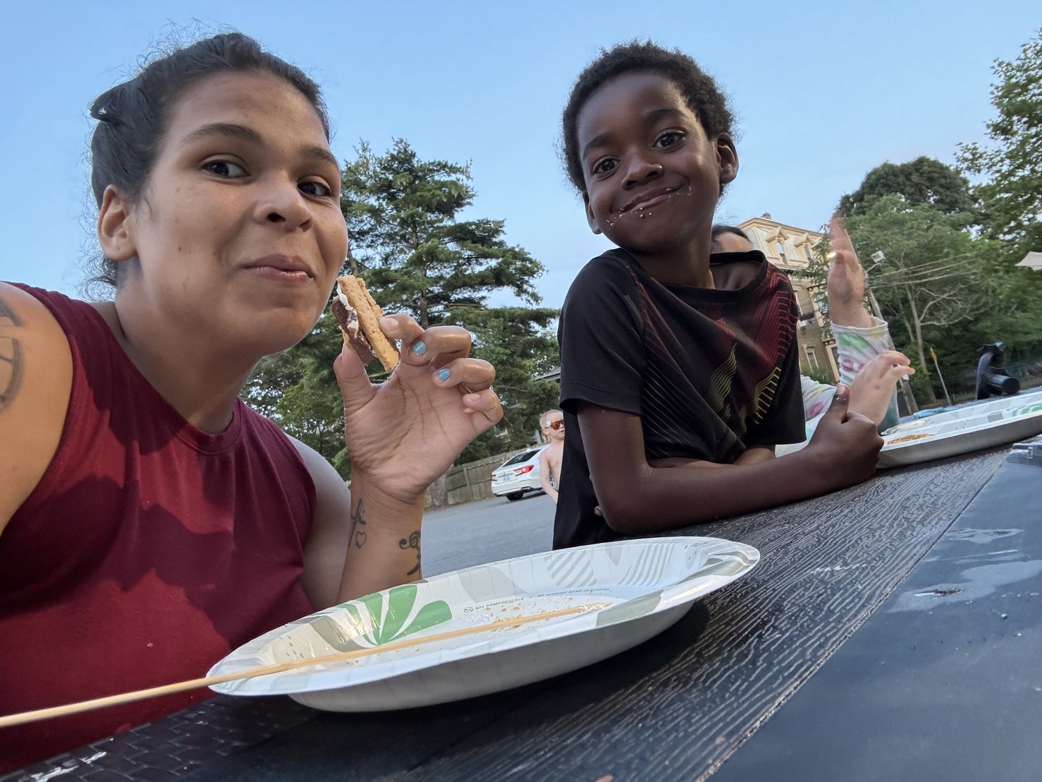 She Thrives mother and child eating s'mores outdoors