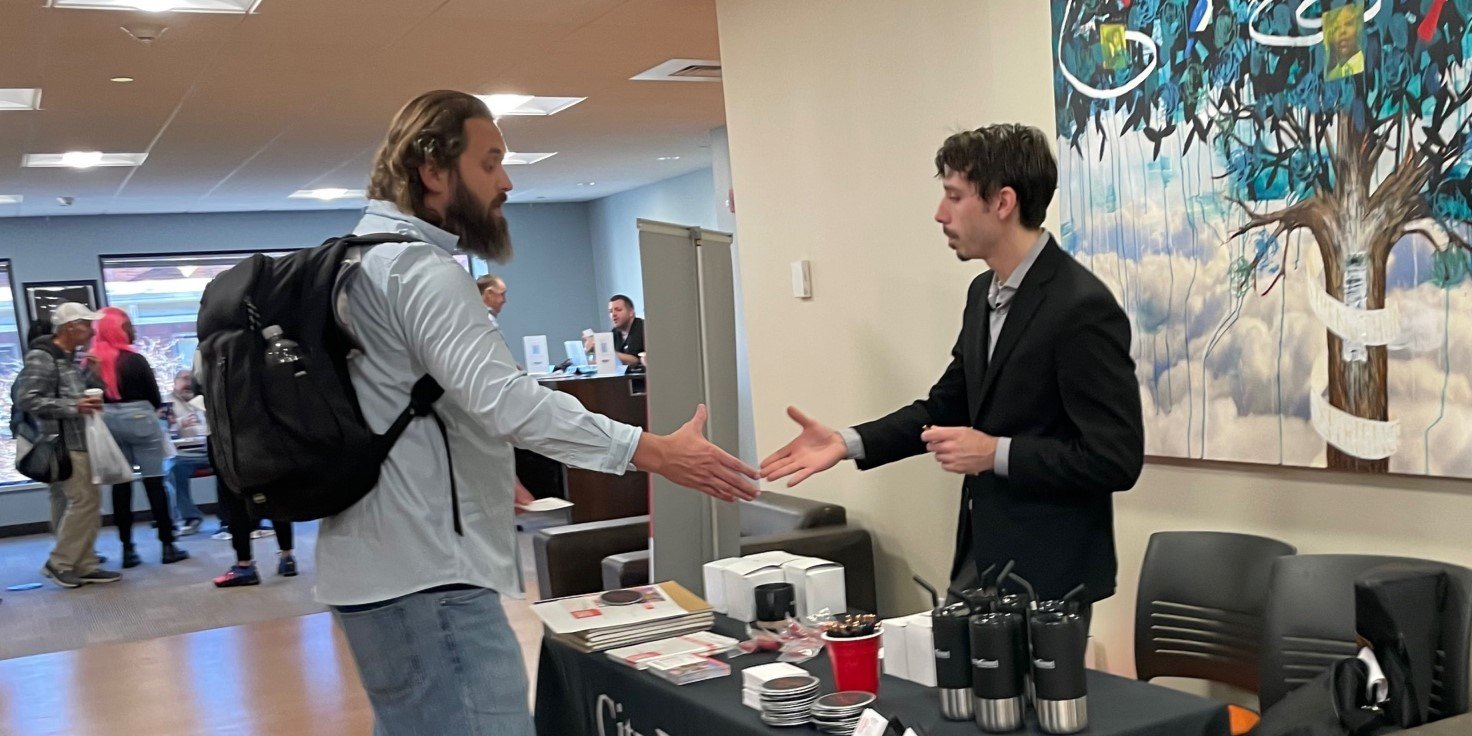 Job seeker shaking hands with an employer at the Fair Chance Job Fair