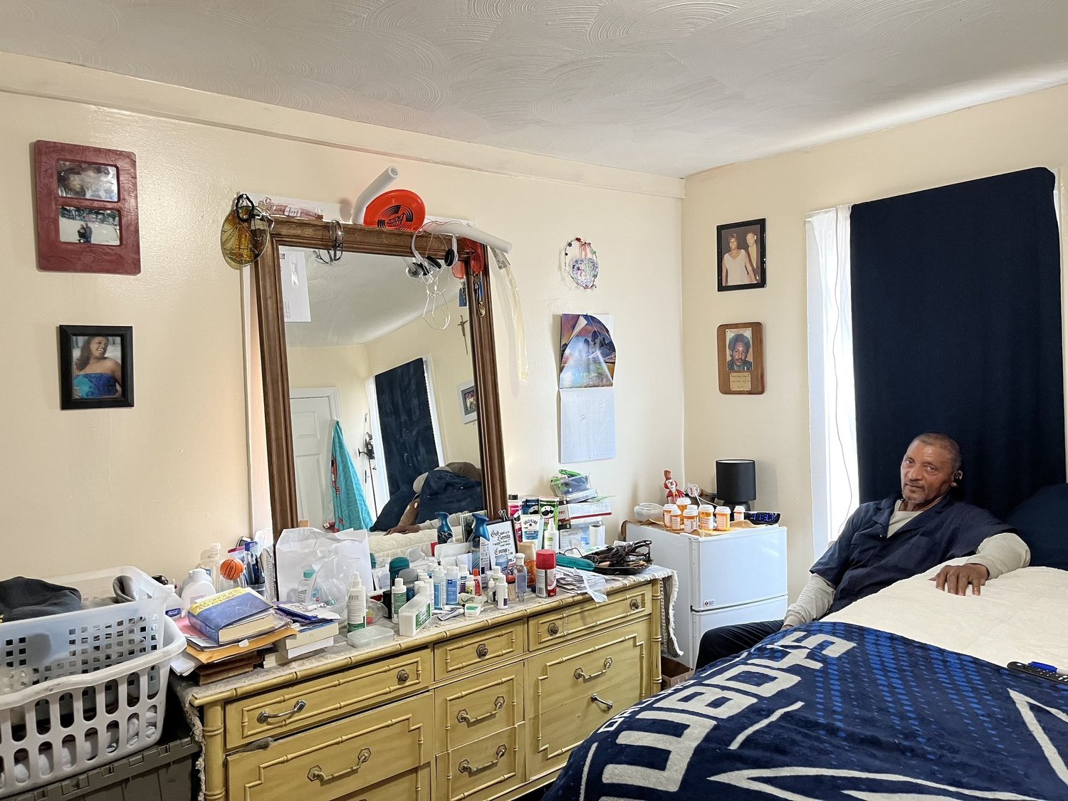 Master-leasing tenant sitting on the bed in his apartment