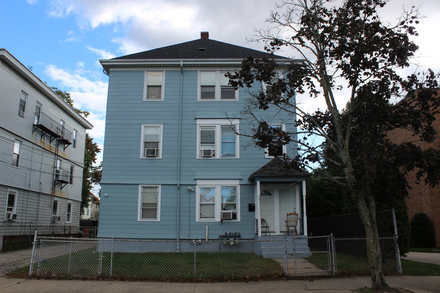 OpenDoors men's transitional house, a blue three-story home