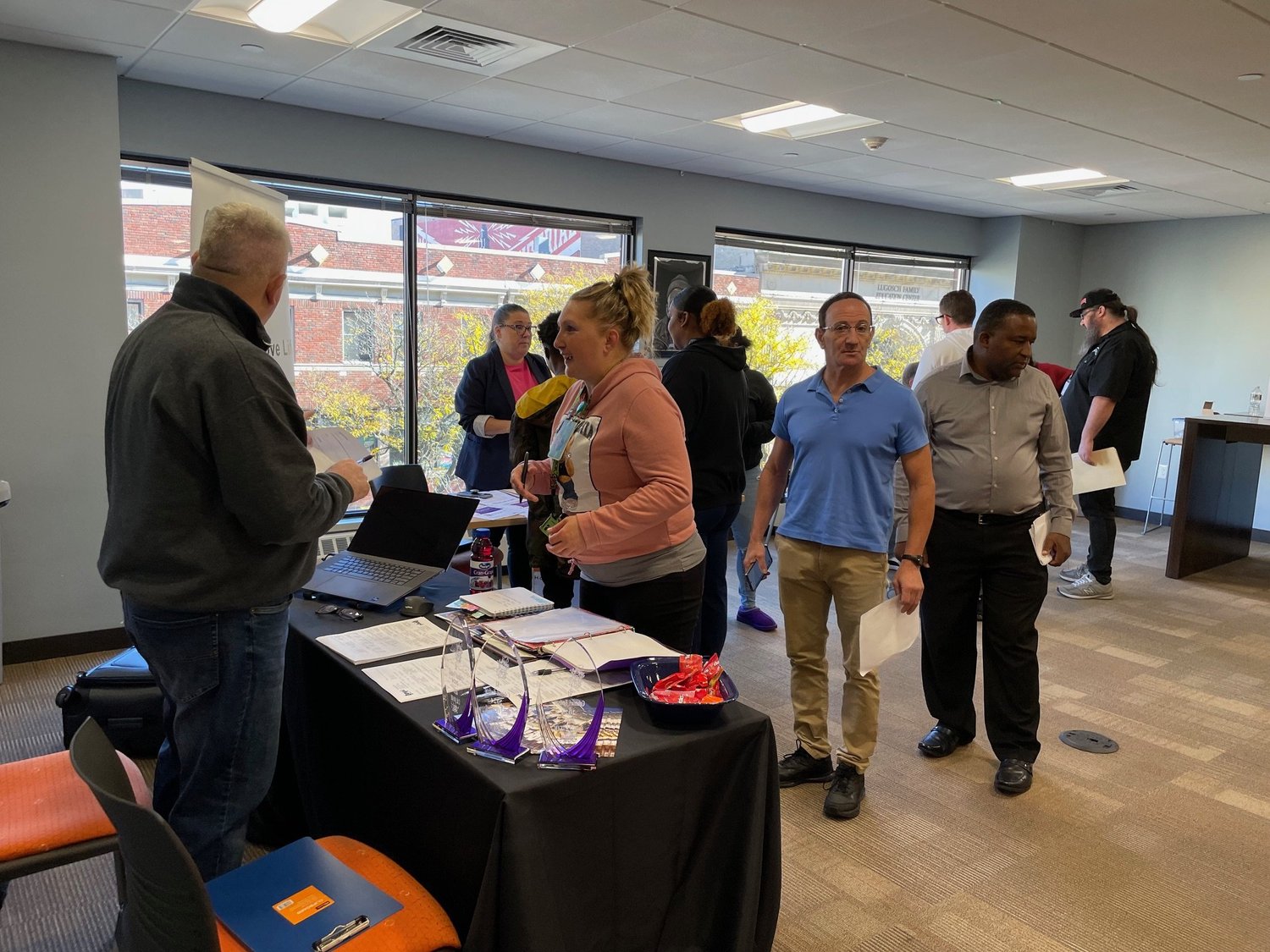 Job seekers lined up at an employer table at the Fair Chance Job Fair