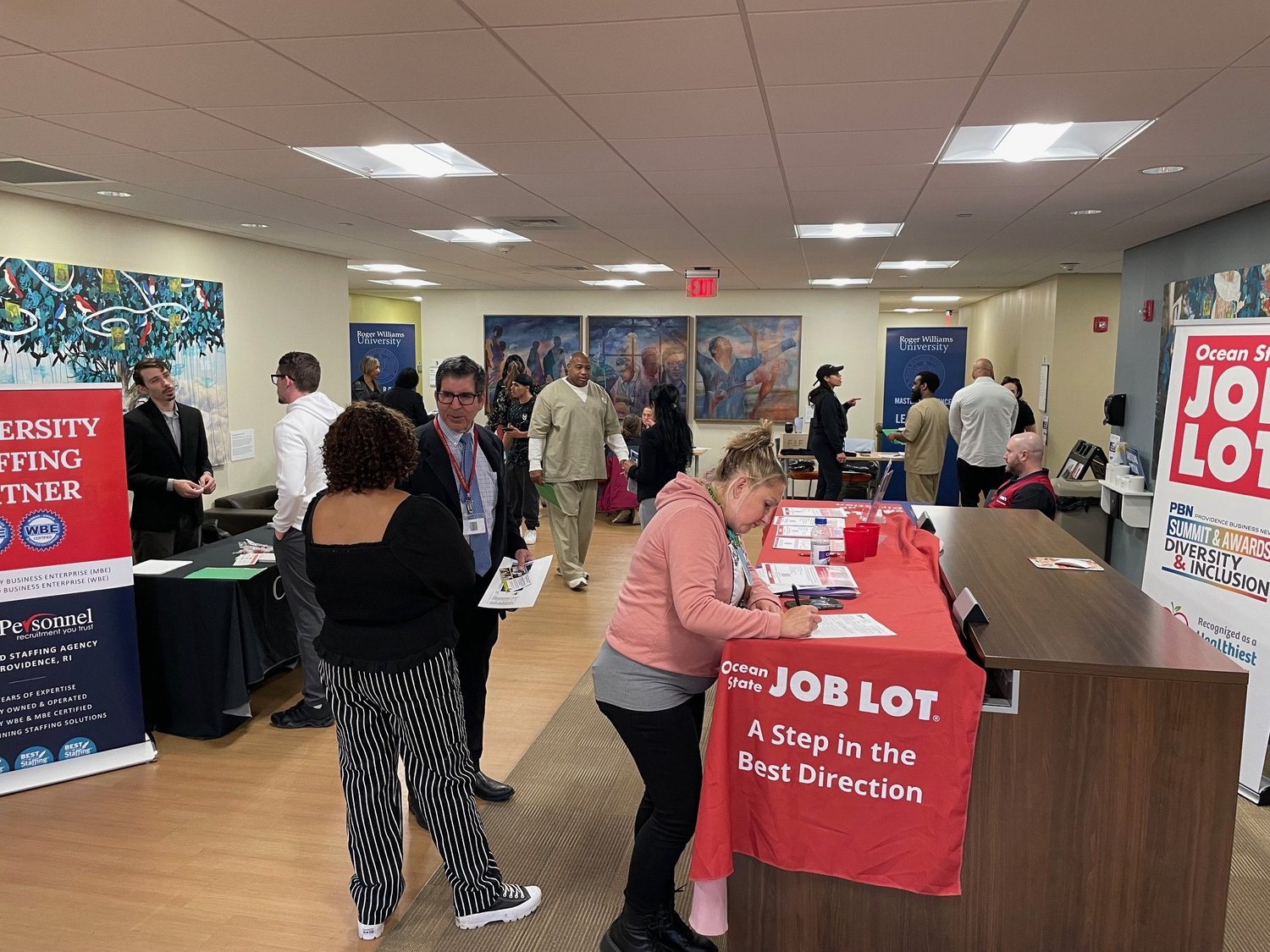 Job seekers and employers at tables during the Fair Chance Job Fair